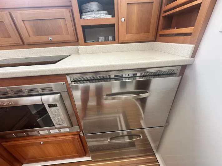 Tlc Yacht Photos Pics 2014 Back Cove 37 yacht kitchen with stainless steel appliances and wooden cabinetry.