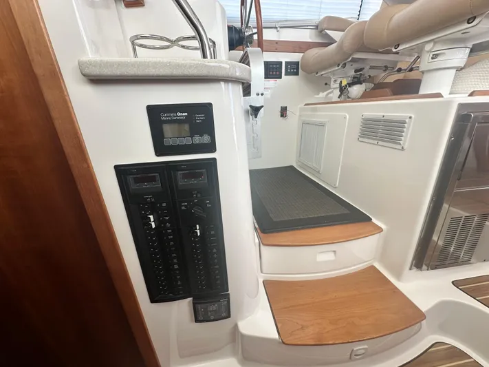 Tlc Yacht Photos Pics 2014 Back Cove 37 yacht interior with control panel and wooden steps.