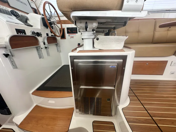 Tlc Yacht Photos Pics Interior of 2014 Back Cove 37 boat with helm, wooden steps, and stainless steel fridge.