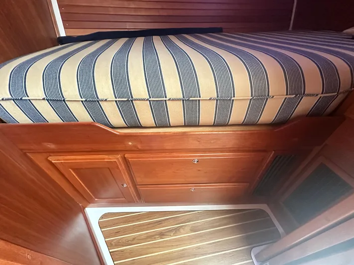 Tlc Yacht Photos Pics 2014 Back Cove 37 interior with striped cushion and wooden cabinetry.