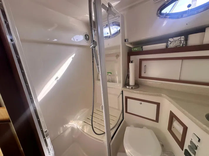 Tlc Yacht Photos Pics 2014 Back Cove 37 yacht bathroom with shower, toilet, and storage cabinets.