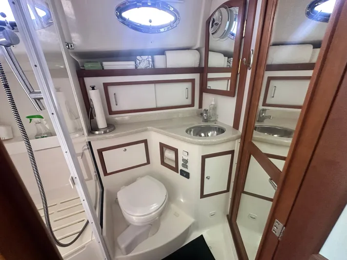 Tlc Yacht Photos Pics 2014 Back Cove 37 yacht bathroom with sink, toilet, and storage cabinets.