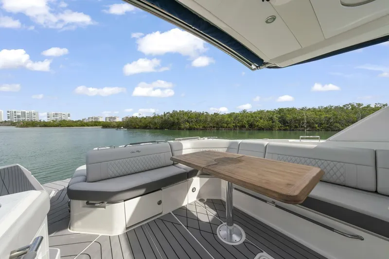  Yacht Photos Pics 2022 Sea Ray SLX 400 Outboard boat interior with elegant seating and wooden table.