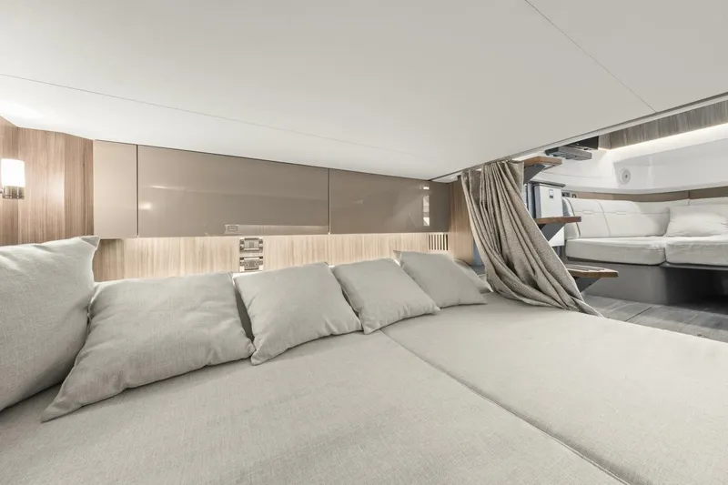  Yacht Photos Pics Luxurious interior of 2022 Sea Ray SLX 400 Outboard, featuring elegant bedding and modern design.
