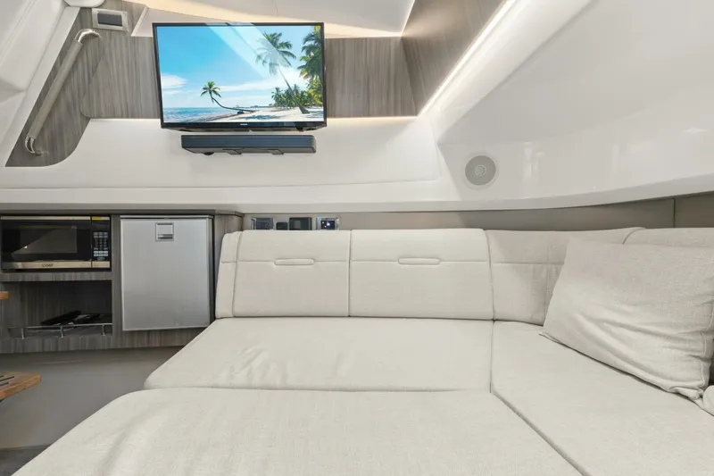 Yacht Photos Pics Interior of 2022 Sea Ray SLX 400 Outboard with sofa, TV, and kitchenette.
