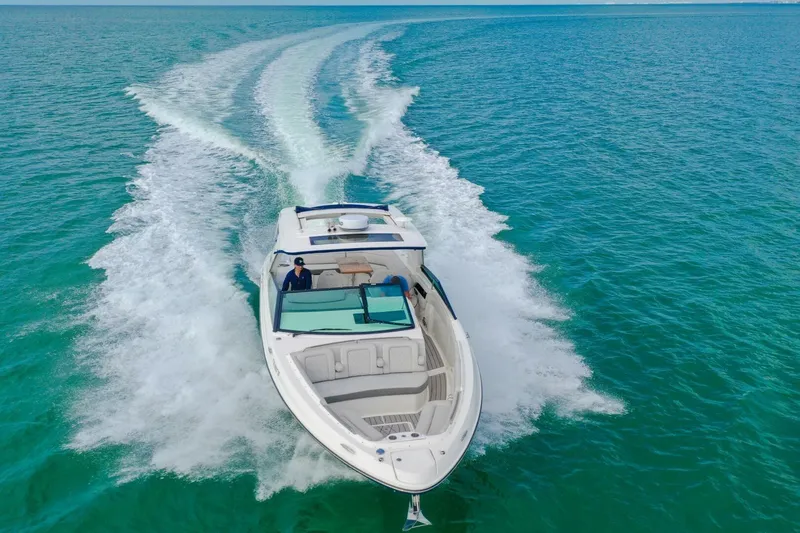  Yacht Photos Pics 2022 Sea Ray SLX 400 Outboard cruising on clear blue water.
