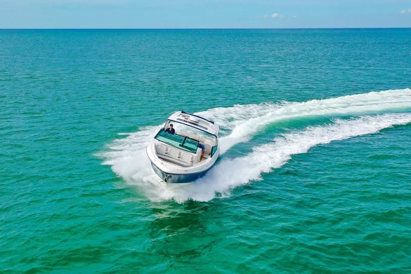  Yacht Photos Pics 2022 Sea Ray SLX 400 Outboard cruising on turquoise ocean waters.