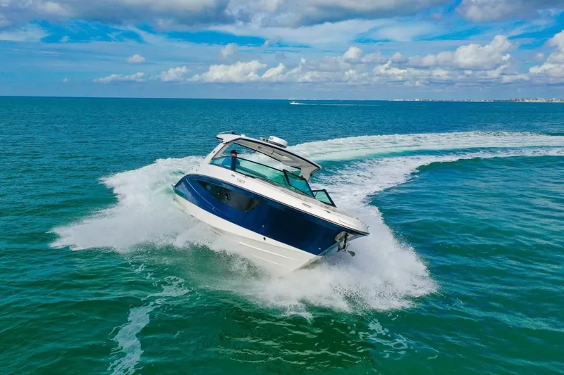  Yacht Photos Pics 2022 Sea Ray SLX 400 Outboard cruising on open ocean under blue sky.