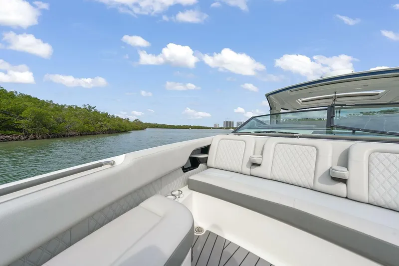  Yacht Photos Pics 2022 Sea Ray SLX 400 Outboard boat interior with luxurious seating on a sunny day.