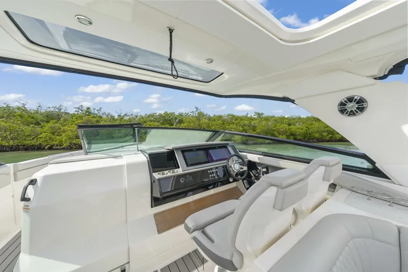  Yacht Photos Pics 2022 Sea Ray SLX 400 Outboard cockpit with modern controls and seating, under a clear sky.