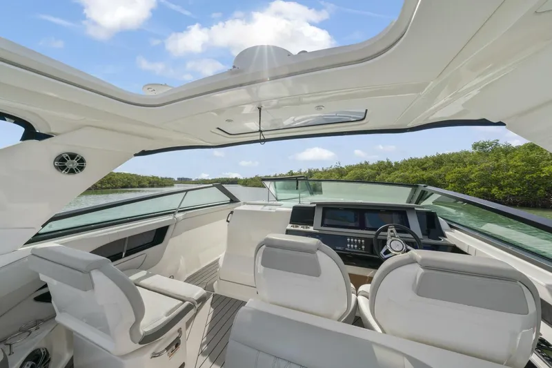  Yacht Photos Pics 2022 Sea Ray SLX 400 Outboard interior with modern helm and seating, under blue sky.