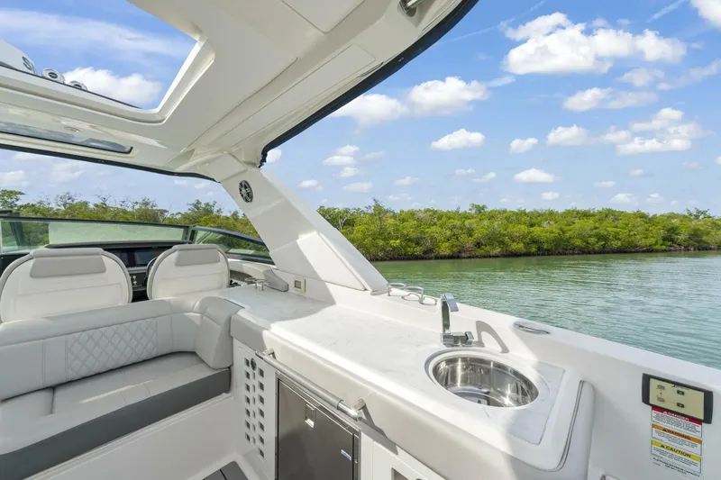  Yacht Photos Pics Luxurious 2022 Sea Ray SLX 400 Outboard interior with sleek seating and scenic water view.