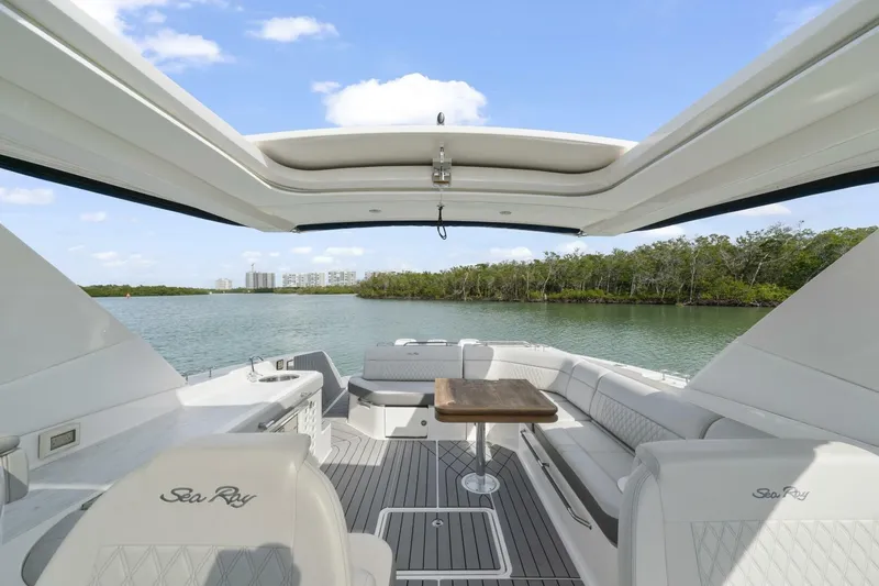  Yacht Photos Pics 2022 Sea Ray SLX 400 Outboard interior with luxurious seating and scenic water view.