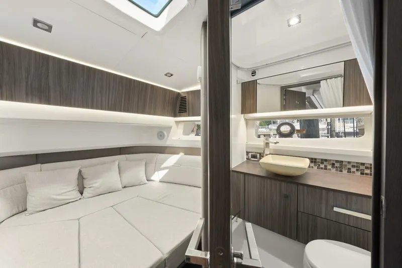  Yacht Photos Pics Luxurious interior of 2022 Sea Ray SLX 400 Outboard, featuring modern seating and elegant bathroom.
