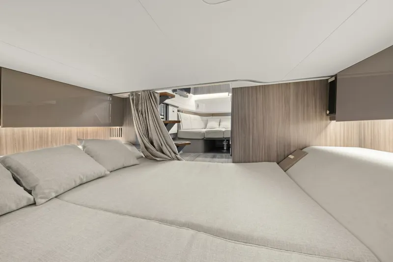  Yacht Photos Pics Luxurious interior cabin of 2022 Sea Ray SLX 400 Outboard yacht, featuring elegant bedding.