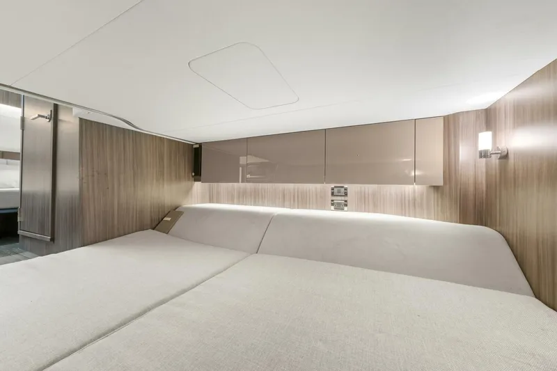  Yacht Photos Pics Luxurious cabin interior of 2022 Sea Ray SLX 400 Outboard with modern wood paneling.