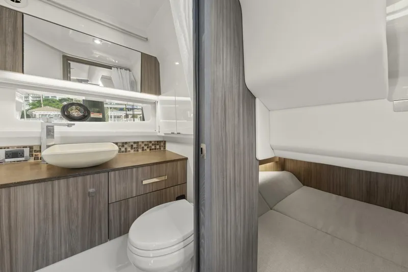  Yacht Photos Pics 2022 Sea Ray SLX 400 Outboard interior with modern bathroom and cozy sleeping area.