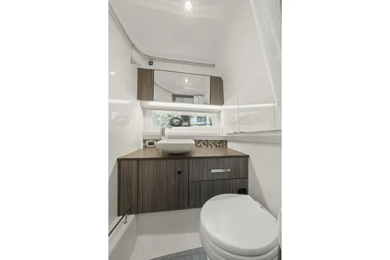  Yacht Photos Pics Luxurious bathroom interior of 2022 Sea Ray SLX 400 Outboard boat, featuring modern fixtures.