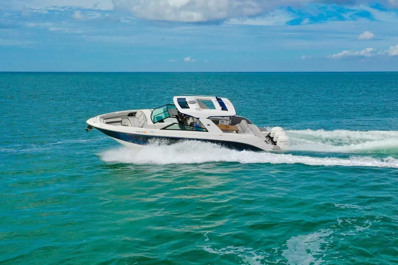  Yacht Photos Pics 2022 Sea Ray SLX 400 Outboard cruising on clear blue ocean waters.