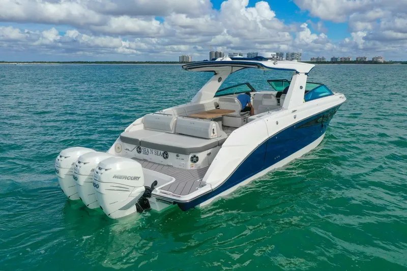 Yacht Photos Pics 2022 Sea Ray SLX 400 Outboard cruising on turquoise waters under a partly cloudy sky.
