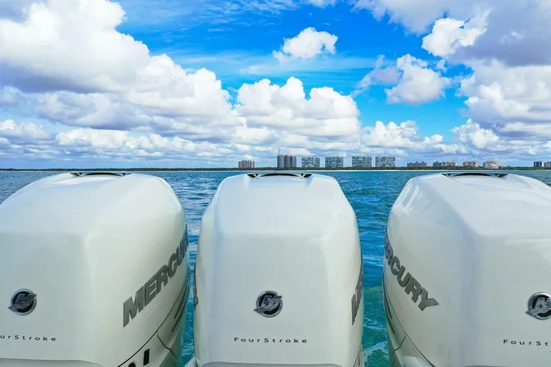  Yacht Photos Pics Three Mercury outboard engines on a 2022 Sea Ray SLX 400, ocean and skyline backdrop.