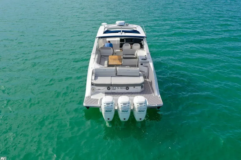  Yacht Photos Pics 2022 Sea Ray SLX 400 Outboard cruising on clear turquoise water.