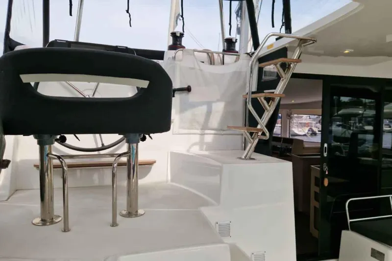 Yacht Photos Pics 2024 Lagoon 42 yacht interior with helm station and modern staircase design.