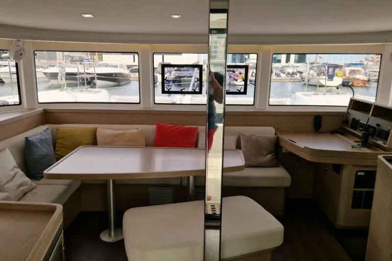  Yacht Photos Pics Interior of 2024 Lagoon 42 catamaran with seating area and large windows.