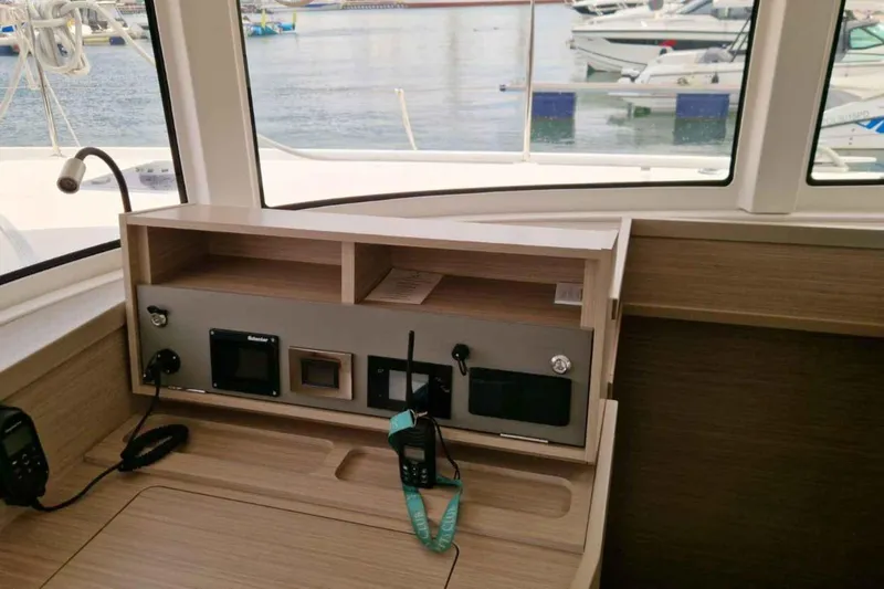  Yacht Photos Pics Interior view of 2024 Lagoon 42 yacht's navigation station with control panel.