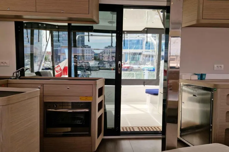  Yacht Photos Pics Interior of 2024 Lagoon 42 yacht with modern kitchen and marina view.