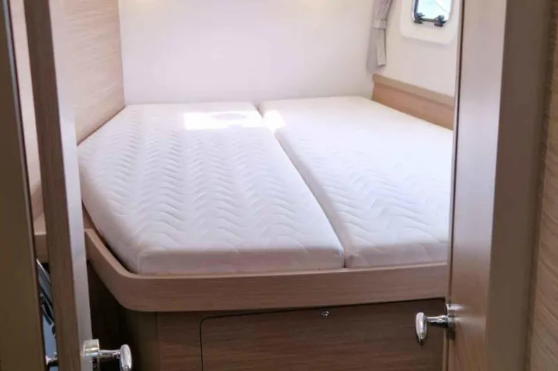  Yacht Photos Pics 2024 Lagoon 42 yacht cabin with comfortable double bed and natural light.