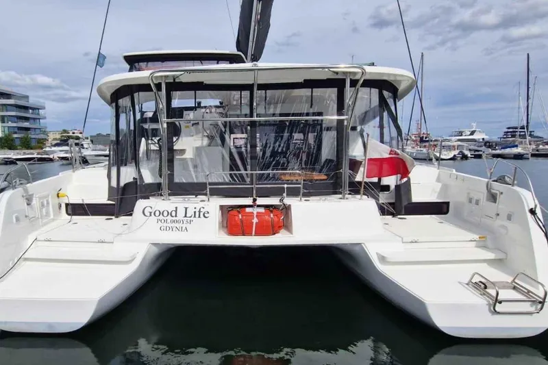  Yacht Photos Pics 2024 Lagoon 42 catamaran "Good Life" docked in a marina, rear view.