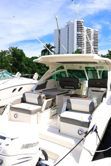  Yacht Photos Pics 2021 Tiara Sport 34 LX boat docked, featuring spacious seating and modern design.