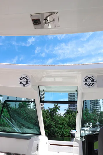  Yacht Photos Pics 2021 Tiara Sport 34 LX boat interior with speakers, blue sky, and waterfront view.