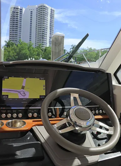  Yacht Photos Pics 2021 Tiara Sport 34 LX helm with navigation display, steering wheel, and cityscape view.
