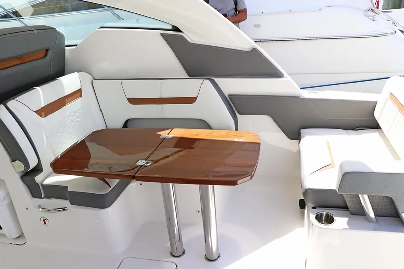  Yacht Photos Pics 2021 Tiara Sport 34 LX interior with elegant seating and wooden table.