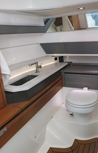  Yacht Photos Pics 2021 Tiara Sport 34 LX yacht interior bathroom with modern fixtures and wood accents.