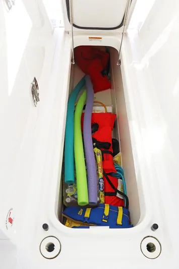  Yacht Photos Pics Storage compartment in 2021 Tiara Sport 34 LX boat with pool noodles and life jackets.