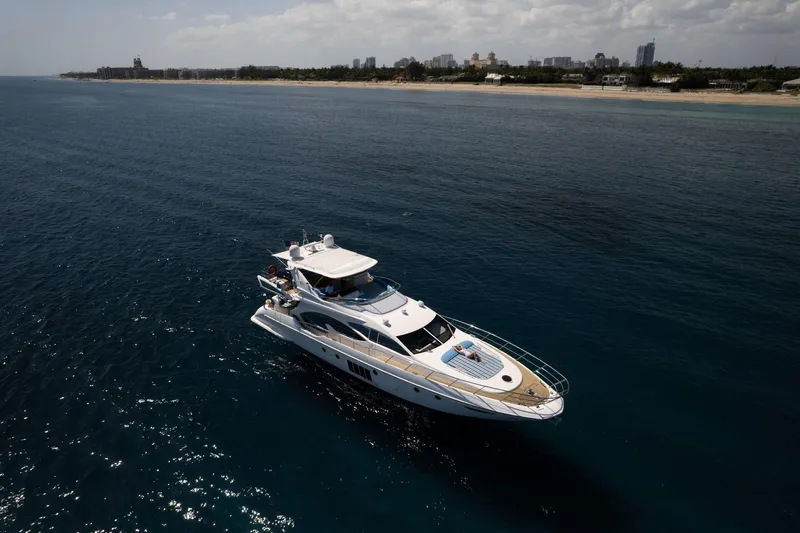 Gigi Yacht Photos Pics Luxurious 2011 Azimut 70 yacht cruising near scenic coastline.