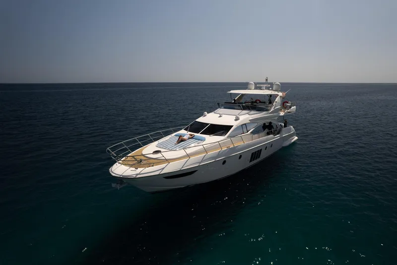 Gigi Yacht Photos Pics Luxurious 2011 Azimut 70 yacht cruising on calm, open sea under clear skies.