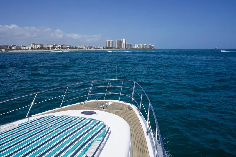 Gigi Yacht Photos Pics Azimut 70 yacht cruising near coastline, clear blue ocean, 2011 model.