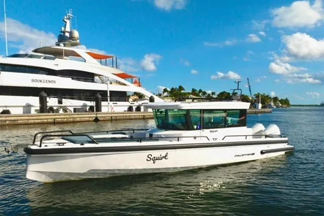 Squirt Yacht Photos Pics 2023 Axopar 28 CABIN boat cruising in a sunny marina setting.