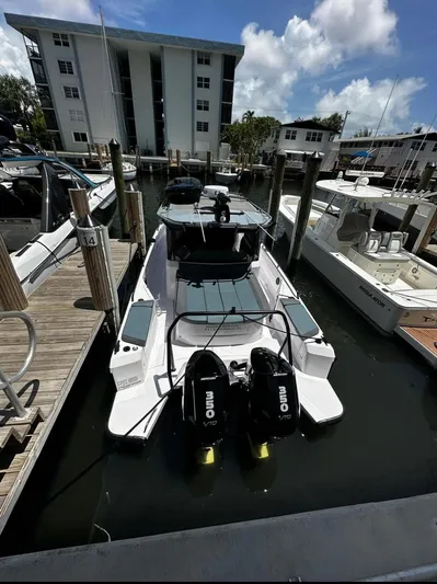 Yacht Photos Pics 2024 Axopar 37 XC Cross Cabin BRABUS Trim docked at marina under blue sky.