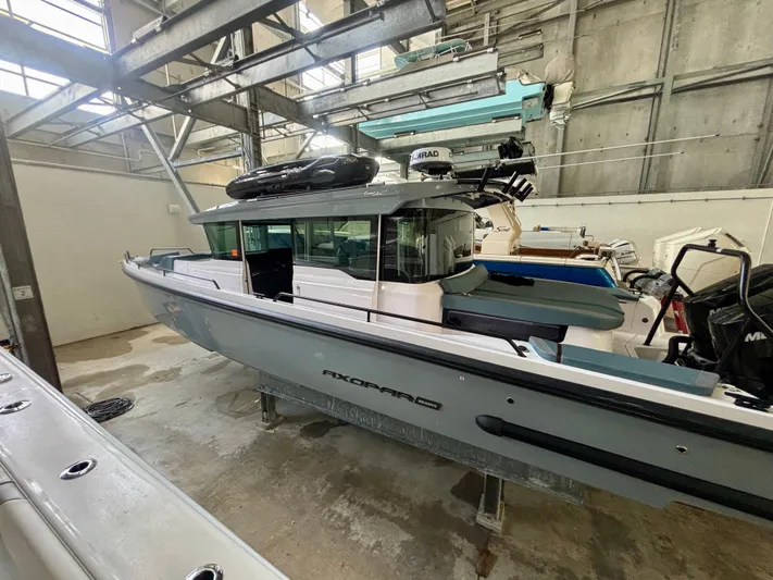  Yacht Photos Pics 2024 Axopar 37 XC Cross Cabin BRABUS Trim in a warehouse setting.