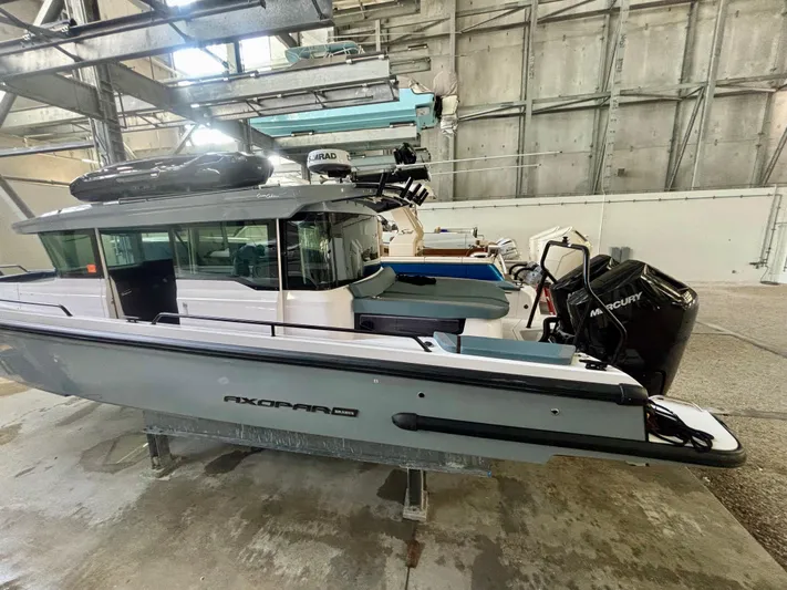  Yacht Photos Pics 2024 Axopar 37 XC Cross Cabin BRABUS Trim in a storage facility.