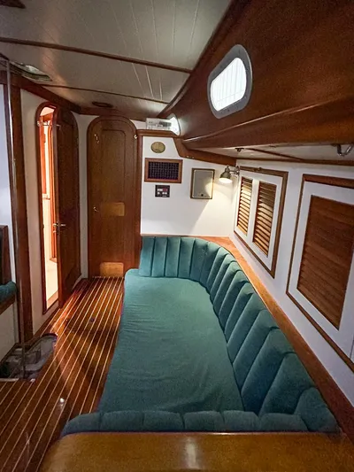 Golden Eye Yacht Photos Pics Interior of 1996 Hinckley Sou'wester 42 MKII with teal seating and wooden accents.