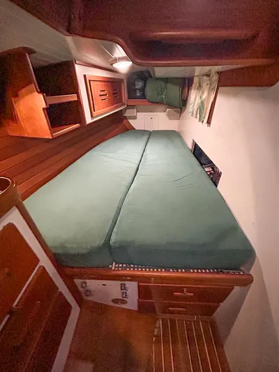 Golden Eye Yacht Photos Pics Cabin interior of 1996 Hinckley Sou'wester 42 MKII with green bedding and wooden furnishings.