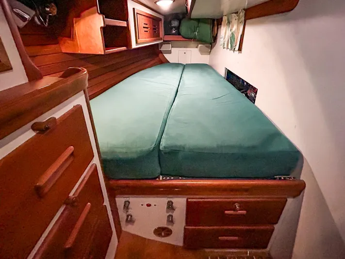 Golden Eye Yacht Photos Pics Hinckley Sou'wester 42 MKII 1996 cabin interior with green bedding and wooden cabinetry.