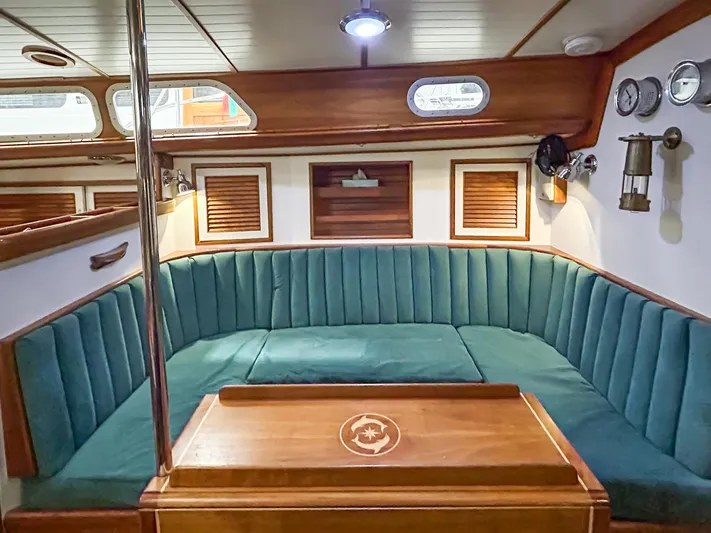 Golden Eye Yacht Photos Pics Interior of 1996 Hinckley Sou'wester 42 MKII yacht with teal seating and wooden accents.
