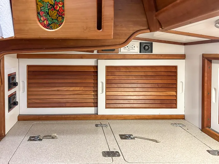 Golden Eye Yacht Photos Pics Interior of 1996 Hinckley Sou'wester 42 MKII with wooden cabinets and storage compartments.